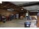 Spacious garage interior with ample storage and workspace, with a white refrigerator and a ladder at 4143 E Maiden Rd, Maiden, NC 28650