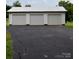 Three-car detached garage with white siding and asphalt driveway at 4143 E Maiden Rd, Maiden, NC 28650