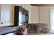 Kitchen with stainless steel appliances, white cabinets, and tile backsplash at 4143 E Maiden Rd, Maiden, NC 28650
