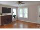 Comfortable living room with hardwood floors, a brick fireplace, and natural light at 4143 E Maiden Rd, Maiden, NC 28650