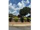 Landscaped median in front of the clubhouse with bright summer flowers and manicured bushes at 4210 Holly Ne Cir, Conover, NC 28613