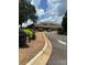 Beautiful clubhouse entrance with meticulous landscaping, mature trees, and circular driveway at 4210 Holly Ne Cir, Conover, NC 28613