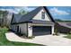 Charming exterior view showcasing attached garage, white brick, lush lawn, and meticulously landscaped surroundings at 4210 Holly Ne Cir, Conover, NC 28613