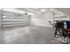Spacious three car garage with three white doors, overhead lighting, and sealed concrete floor at 4210 Holly Ne Cir, Conover, NC 28613