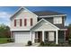 Charming two-story home features a classic design with a two-car garage and inviting front porch at 4457 Family Trail Dr, Indian Land, SC 29707