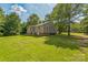 Spacious, grassy backyard with mature trees, surrounding a cozy home at 4699 Cherrystone Rd, Lancaster, SC 29720