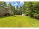 Expansive backyard with lush green grass and storage shed at 4699 Cherrystone Rd, Lancaster, SC 29720