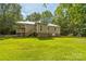 Large, well-maintained backyard with a covered porch, perfect for outdoor enjoyment at 4699 Cherrystone Rd, Lancaster, SC 29720