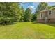 Well-manicured backyard with a storage shed and surrounded by mature trees, offering a private and serene setting at 4699 Cherrystone Rd, Lancaster, SC 29720