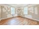 Bright bedroom with hardwood floors and natural light from two windows, ready for customization at 4699 Cherrystone Rd, Lancaster, SC 29720