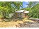 Charming home with a metal roof, a welcoming porch, and mature trees providing shade at 4699 Cherrystone Rd, Lancaster, SC 29720