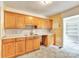 Kitchen with wooden cabinets, countertop space, and a view into another room at 4699 Cherrystone Rd, Lancaster, SC 29720