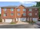 Charming red brick townhome with attached garages and well-maintained landscaping and traditional architectural details at 4708 S Hill View Dr, Charlotte, NC 28210