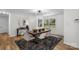 Bright dining room with a modern light fixture, hardwood floors, and dining table at 4932 Delivau Dr, Charlotte, NC 28215
