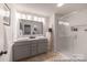 Bathroom featuring a double sink vanity, decorative ladder, and a glass-enclosed shower with tiled walls at 622 Station St # 48, Clover, SC 29710