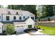 Charming, new construction townhome featuring a white exterior, garage and well-manicured lawn at 622 Station St # 48, Clover, SC 29710