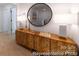 Hallway featuring a modern wood cabinet, stylish decor, and a round mirror at 622 Station St # 48, Clover, SC 29710