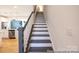 A modern staircase featuring dark wood steps, white risers, and a dark wood railing at 622 Station St # 48, Clover, SC 29710