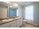 Bright bathroom with a double vanity and large mirror at 6785 Knotty Wood Ln, Vale, NC 28168