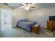 Cozy bedroom with neutral walls, ceiling fan, and carpet flooring, creating a warm and inviting space at 6785 Knotty Wood Ln, Vale, NC 28168