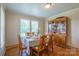Elegant dining room with hardwood floors, a large window, and stylish wooden furniture at 6785 Knotty Wood Ln, Vale, NC 28168