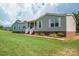 Charming single-story home featuring a welcoming front porch, gray siding, and a well-maintained lawn at 6785 Knotty Wood Ln, Vale, NC 28168