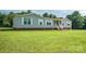Charming single-story home featuring a welcoming front porch, gray siding, and a well-maintained lawn at 6785 Knotty Wood Ln, Vale, NC 28168