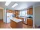 Functional kitchen featuring an island and lots of storage space with the plentiful wooden cabinets at 6785 Knotty Wood Ln, Vale, NC 28168