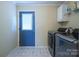 Well-equipped laundry room includes modern washer, dryer, and storage at 6785 Knotty Wood Ln, Vale, NC 28168