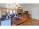 Inviting living room featuring a cozy fireplace, comfortable seating, and hardwood flooring at 6785 Knotty Wood Ln, Vale, NC 28168