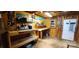 Interior of shed with work benches and exposed lighting, creating a functional space for projects and storage at 6785 Knotty Wood Ln, Vale, NC 28168