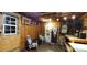 Inside view of a storage shed with wooden walls, illuminated by exposed lighting, creating a functional workshop space at 6785 Knotty Wood Ln, Vale, NC 28168