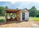 Storage shed with covered area, offering practical outdoor storage solutions with easy access at 6785 Knotty Wood Ln, Vale, NC 28168