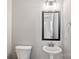 Cozy half-bath with pedestal sink, modern fixtures, framed mirror, and tiled floor at 6907 Hunts Mesa Dr, Fort Mill, SC 29707