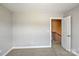 Spacious bedroom shows a white door and stairway to the upper or lower level at 6907 Hunts Mesa Dr, Fort Mill, SC 29707