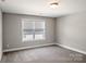 Standard bedroom with neutral carpeting and paint and a window with neighborhood views at 6907 Hunts Mesa Dr, Fort Mill, SC 29707