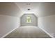 Spacious bonus room on the upper level with carpeted floors and a bright window at 6907 Hunts Mesa Dr, Fort Mill, SC 29707