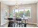 Bright dining room features a large window and unique industrial dining table at 6907 Hunts Mesa Dr, Fort Mill, SC 29707