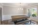 Well-lit dining room featuring a modern chandelier, large window, and classic wainscoting detail at 6907 Hunts Mesa Dr, Fort Mill, SC 29707
