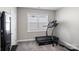 Home exercise room with a treadmill and weight training equipment near a bright window at 6907 Hunts Mesa Dr, Fort Mill, SC 29707
