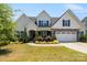 Charming two-story home features a manicured front yard, stone accents, and a welcoming two-car garage at 6907 Hunts Mesa Dr, Fort Mill, SC 29707