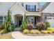 Inviting entrance with stone accents, lush landscaping, and a covered front porch, creating curb appeal at 6907 Hunts Mesa Dr, Fort Mill, SC 29707