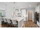 Bright kitchen features a large center island, modern lighting, and white cabinets at 6907 Hunts Mesa Dr, Fort Mill, SC 29707