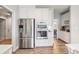 Stainless steel refrigerator and ovens compliment the white cabinets in this kitchen at 6907 Hunts Mesa Dr, Fort Mill, SC 29707
