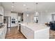 Spacious kitchen with white cabinets, stainless steel appliances, and a large center island with seating at 6907 Hunts Mesa Dr, Fort Mill, SC 29707