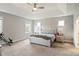 Main bedroom features a tray ceiling, carpet, and multiple windows at 6907 Hunts Mesa Dr, Fort Mill, SC 29707