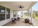 Covered patio featuring a ceiling fan and chairs with fire pit, perfect for outdoor entertaining and relaxation at 6907 Hunts Mesa Dr, Fort Mill, SC 29707