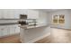 Modern kitchen island with a sink and granite countertops, great for food prep and entertaining at 7213 Jerimoth Dr, Charlotte, NC 28215