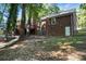 Brick home featuring a backyard with mature trees and a wooden deck at 9334 New Towne Dr, Matthews, NC 28105