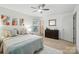 Bedroom with wood floor, ceiling fan, and decoratively adorned comfortable bed at 9334 New Towne Dr, Matthews, NC 28105